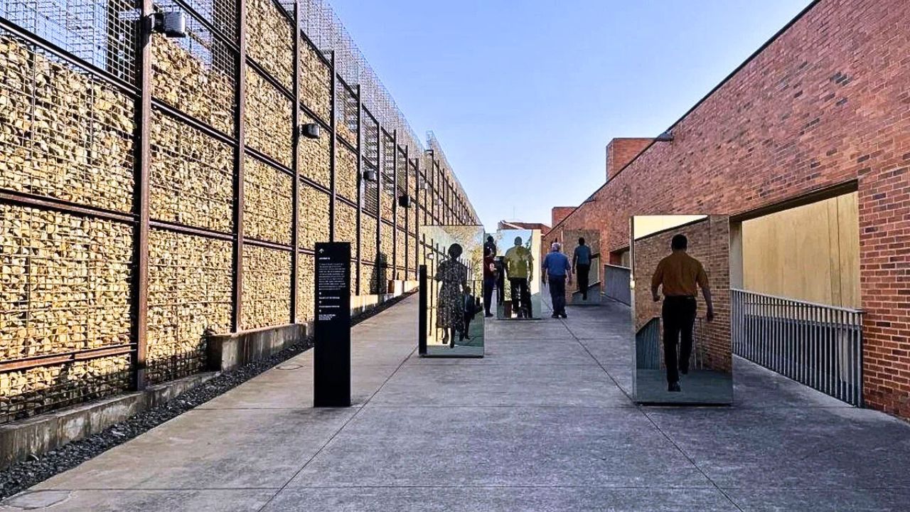 Apartheid Museum pathway with images of people displayed along the walkway