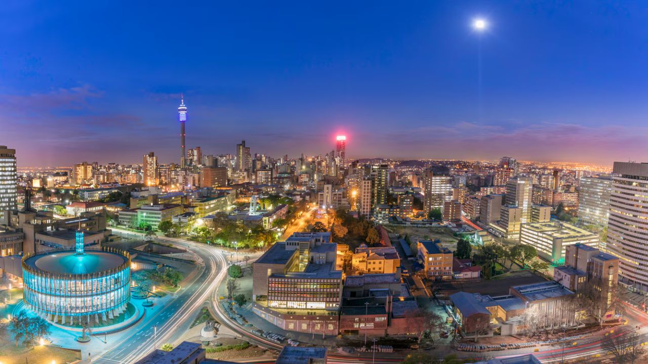 Elevated nighttime view of Johannesburg city with colorful lights