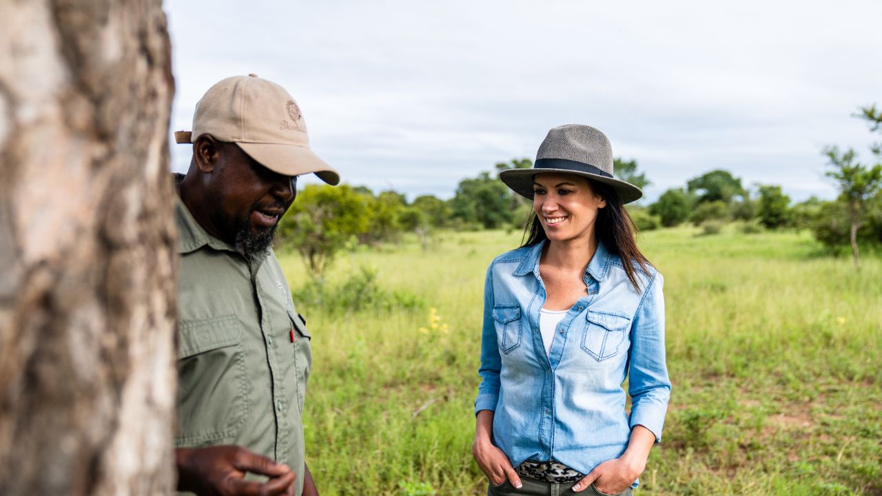 Ranger explaining bush ecology to guests during guided walking safari in Kruger