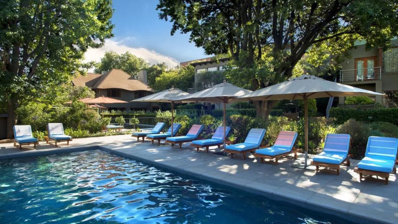 Swimming pool with lounge chairs and decks at Peech Boutique Hotel, Johannesburg