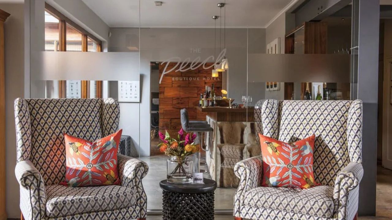 Reception area at Peech Boutique Hotel with two Victorian chairs