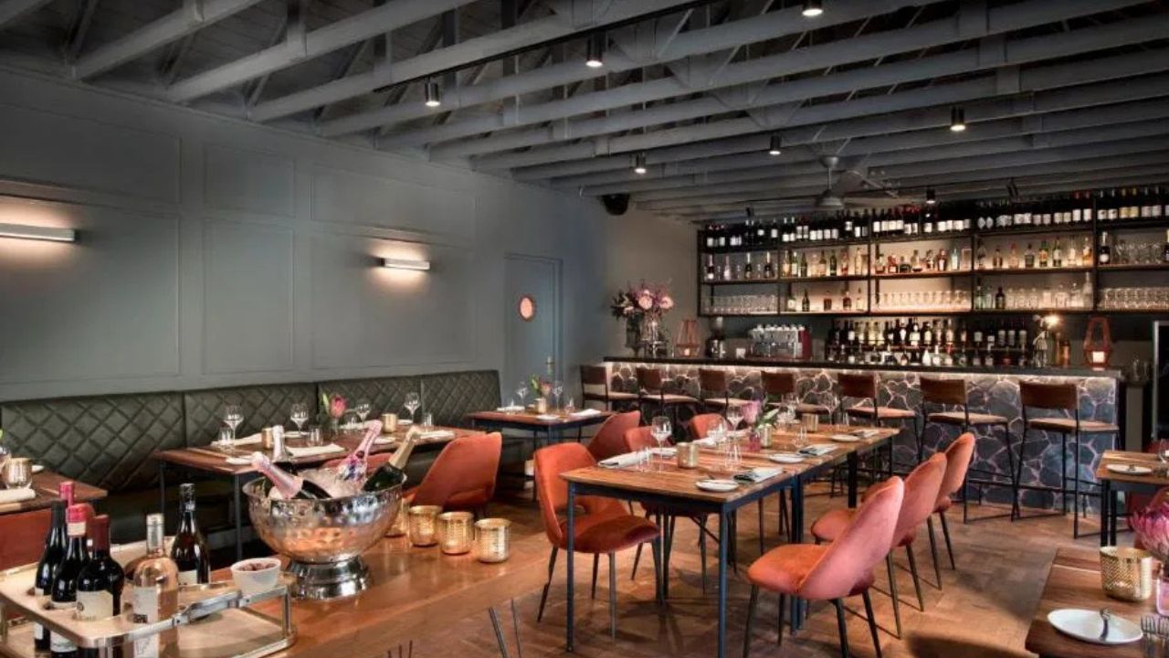 Restaurant dining area at Peech Boutique Hotel with red chairs and long tables