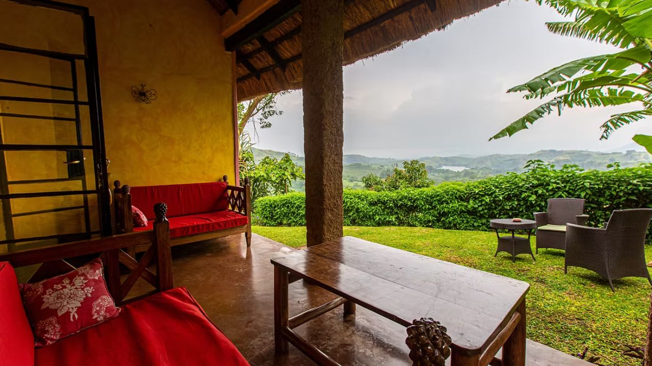 Private deck with seating area overlooking Crater Lake and jungle hills at Ndali Lodge.