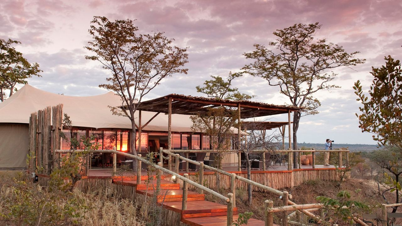Main guest deck area at Wild Horizons Elephant Camp at sunset with a purple sky, Zimbabwe