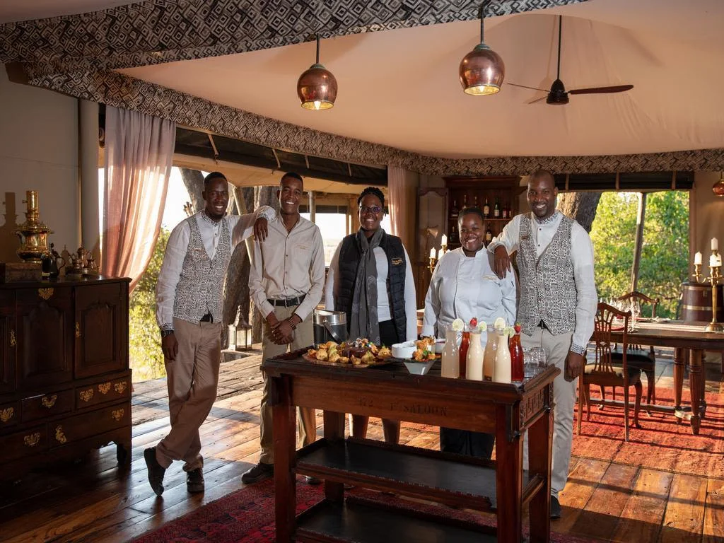 staff serving delicious meal of fruit at Safari Camp, Okavango Delta, Botswana.