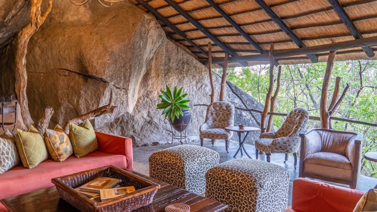 Open-plan lounge and reception at Amalinda Lodge under thatch roof