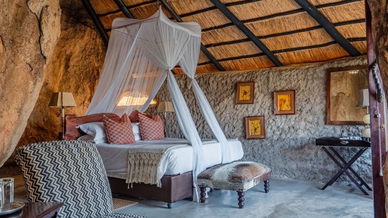 Side view of luxury safari suite at Amalinda Lodge built into rock formations