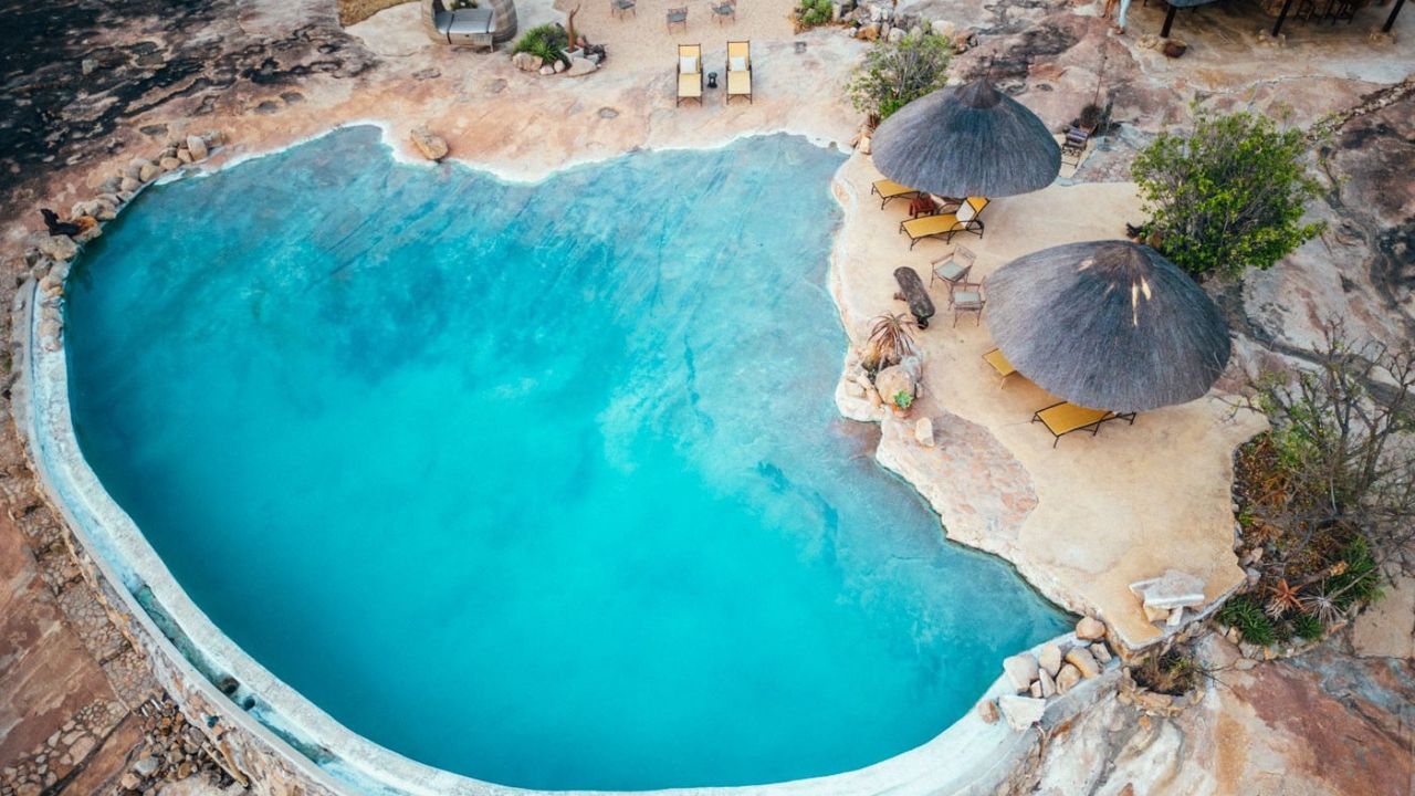 Aerial view of Rockpool at Amalinda Lodge with thatch umbrellas, Zimbabwe safari