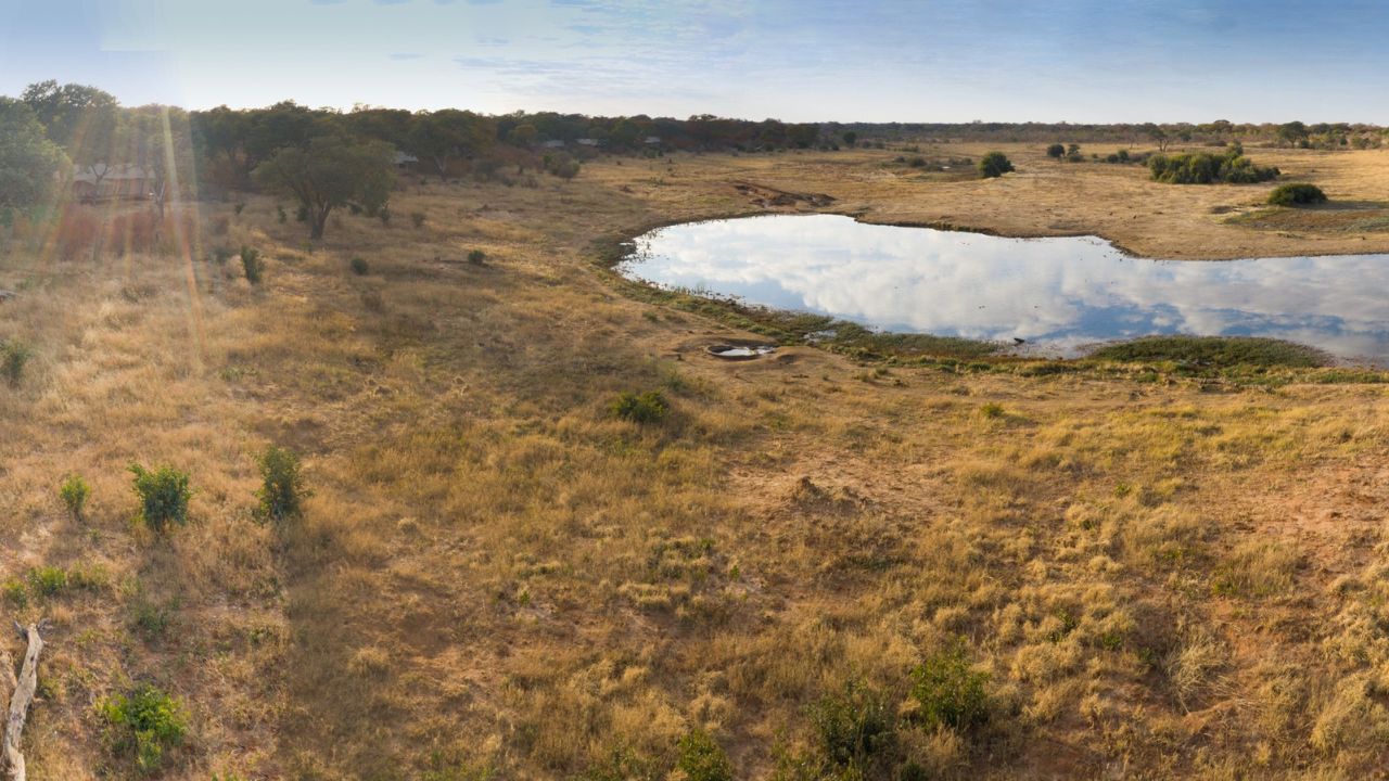 Elevated view of lodge and nearby watering hole, Verny’s Camp