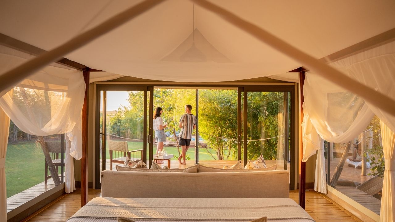 Wide-angle guest room with guests on deck overlooking Lake Kariba, Fothergill Island