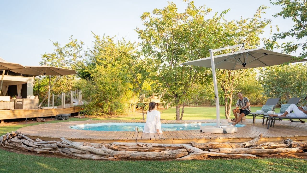 Guests enjoying swimming pool at Fothergill Island lodge, Lake Kariba