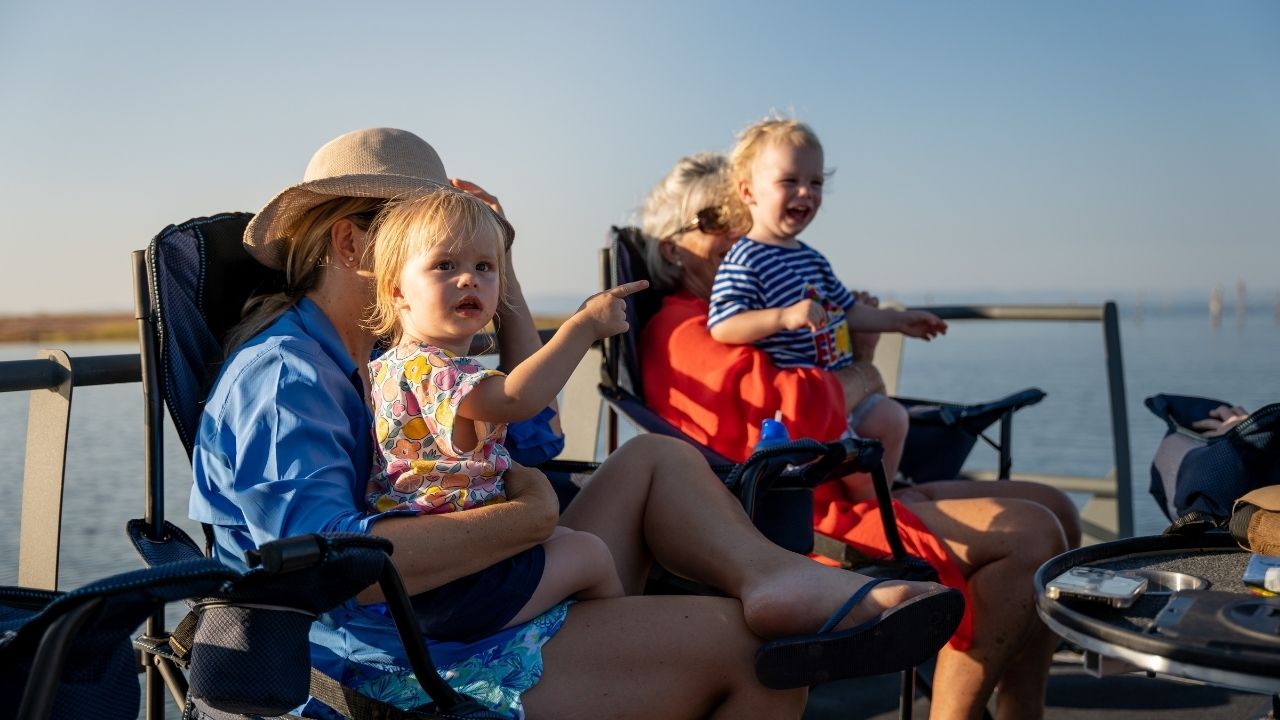 Mom and grandmother holding young children on Lake Kariba cruise