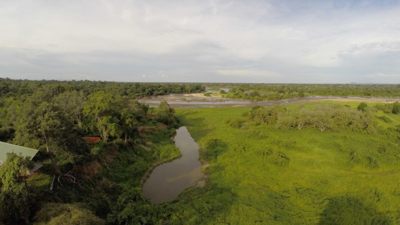 Aerial view of Kavinga Camp watering hole with safari lodge in Mana Pools Zimbabwe