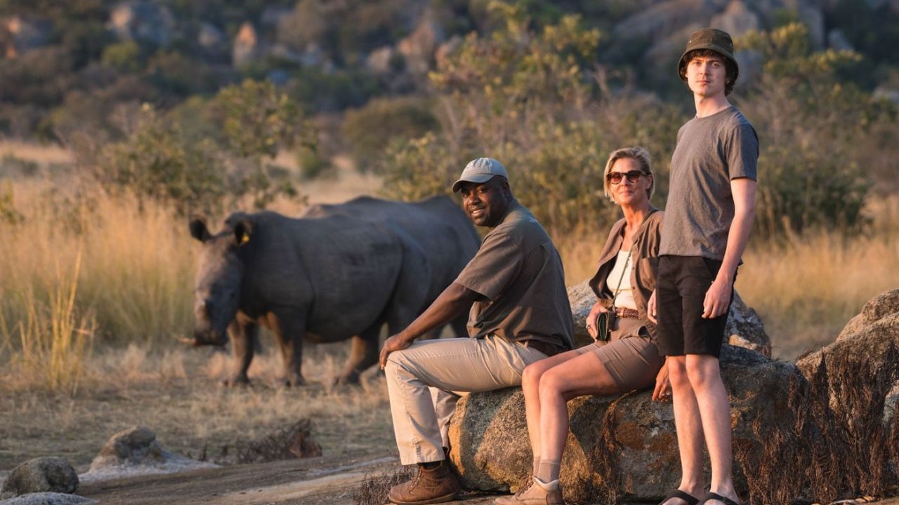 Safari guide with guests observing rare rhino Matobo National Park