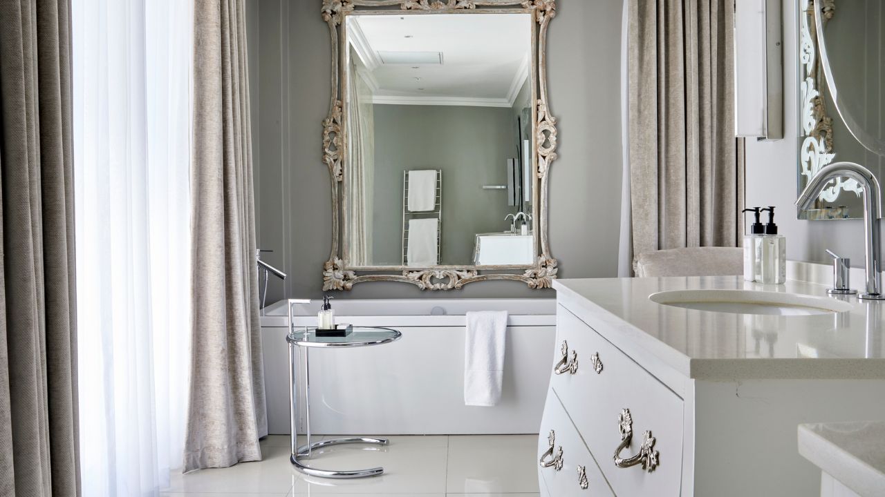 Luxury bathroom in junior suite with white and gold details Queen Victoria Hotel.