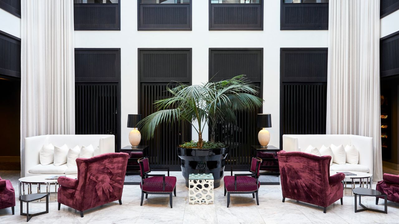 Queen Victoria Hotel reception area with whites and royal purple décor.