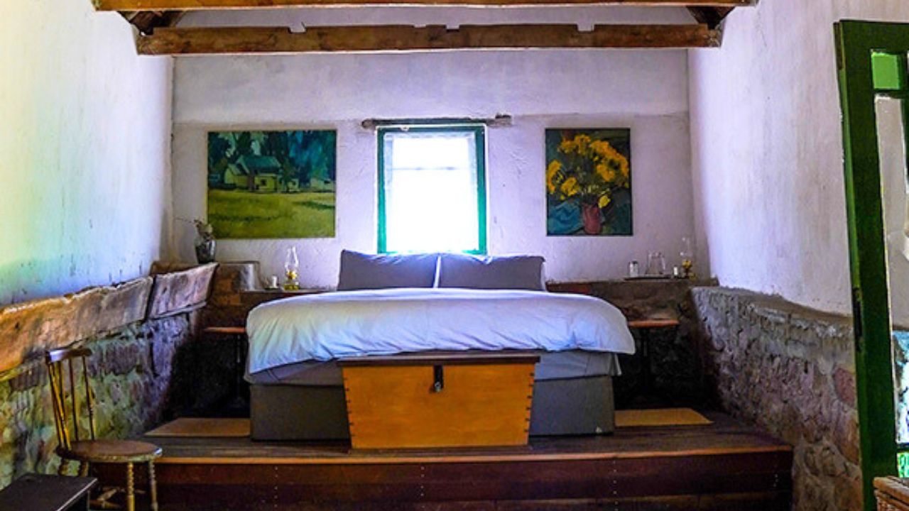 Front view of double bed in rustic farm-style room at Bakkrans.