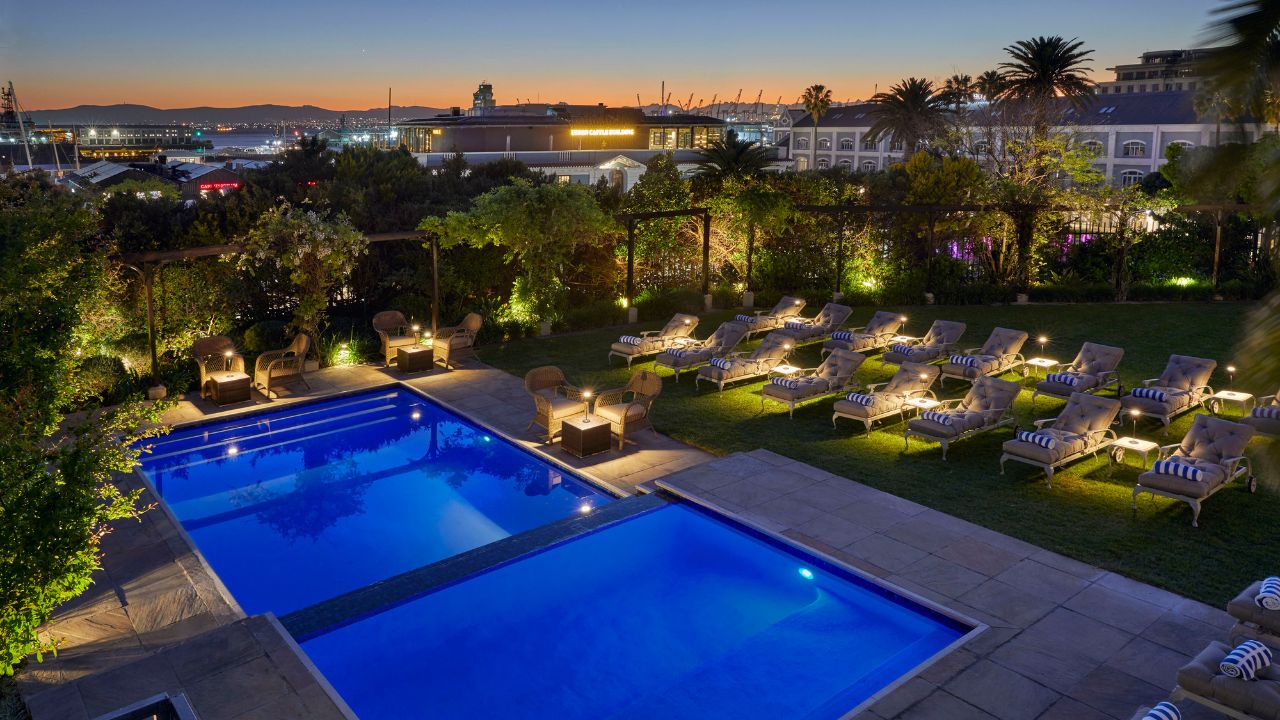 Dock House Boutique Hotel pool at night with sunset lighting Cape Town.