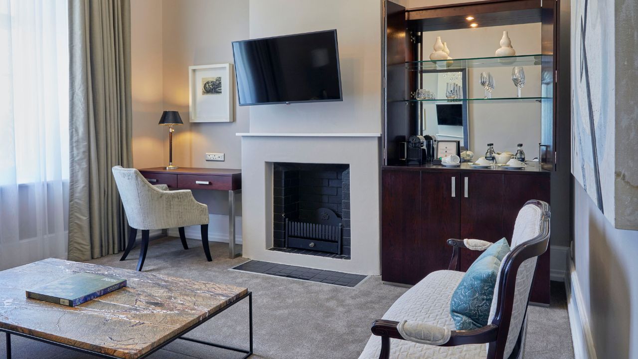 Suite lounge with TV and work area Dock House Boutique Hotel Cape Town.