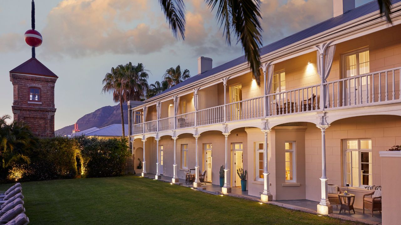 Rear exterior of Dock House Boutique Hotel at sunset with lights on