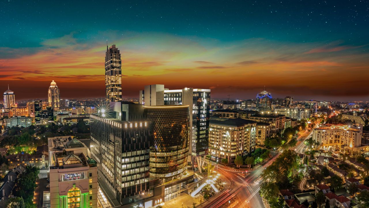Sandton City at sunset with vibrant city lights, Johannesburg South Africa.