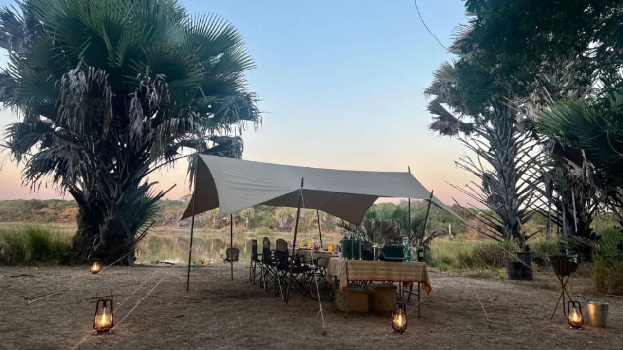 Long-range shot of communal dining area in tented camp.