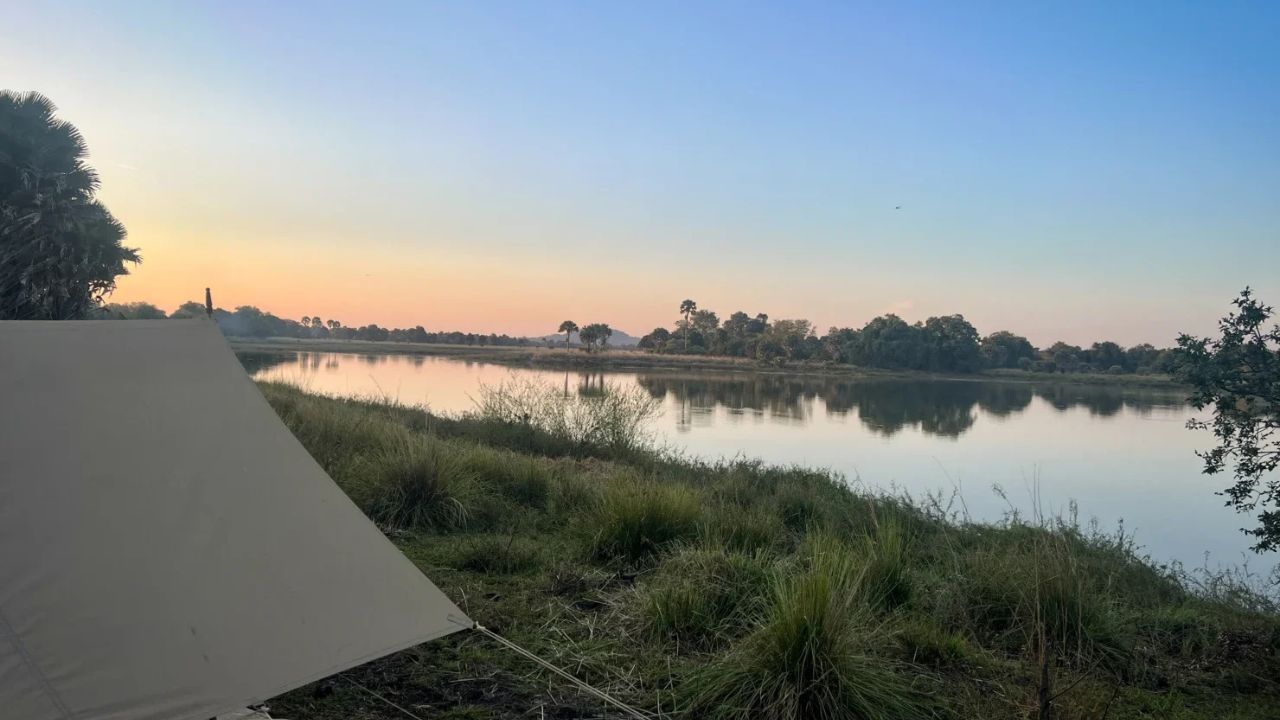 View over tent and river at sunrise in Tanzania.