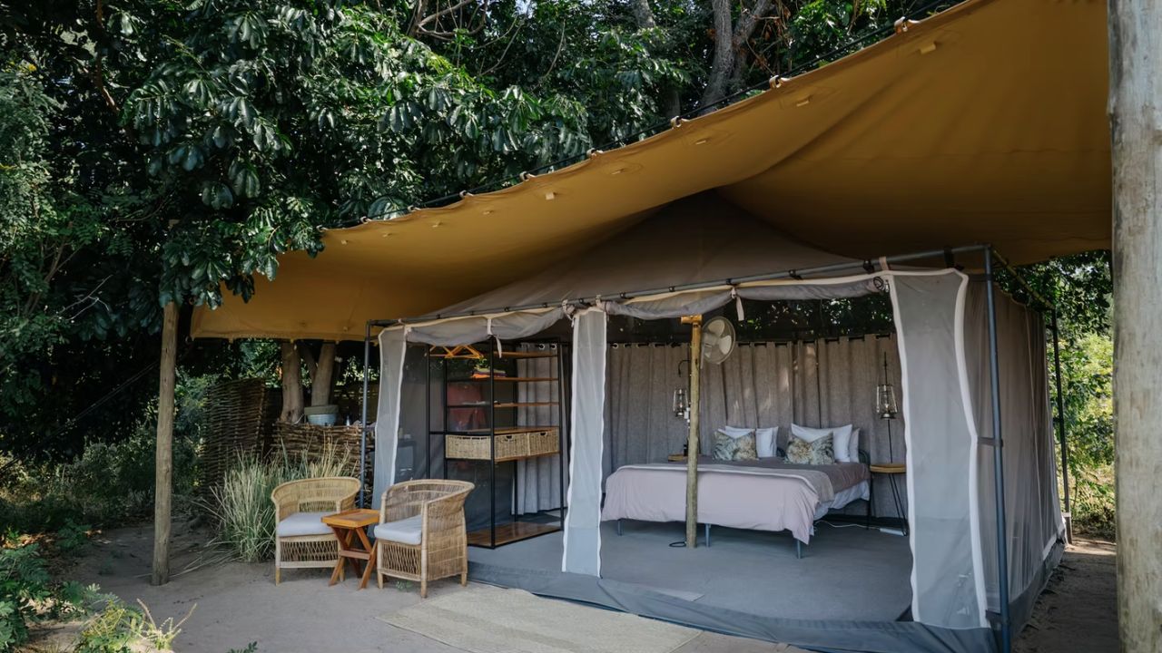Interior view of Chulu Island Camp tented accommodation, showing double bed in open-plan layout.