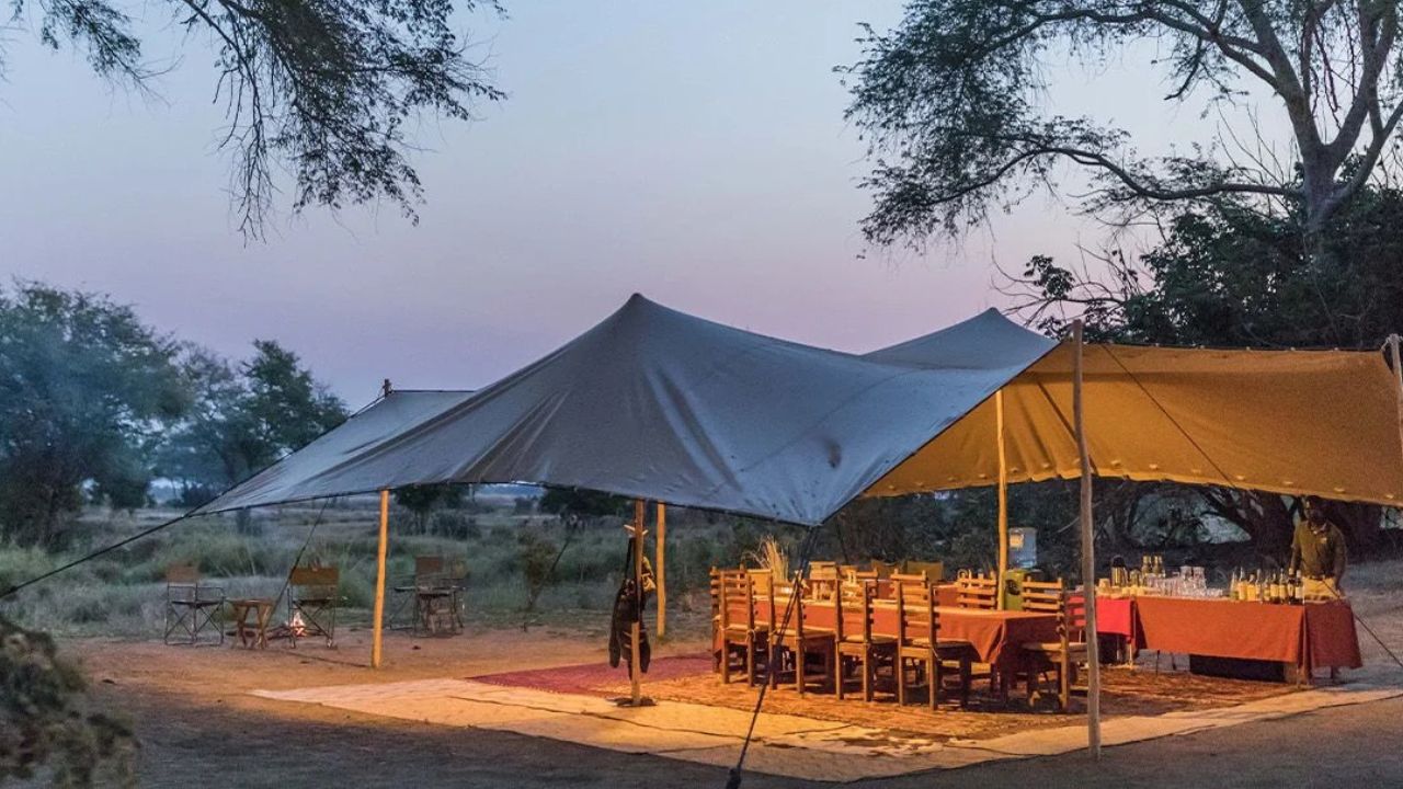 General dining area of Chula Island Camp main lodge, tented accommodation with rustic furnishings.