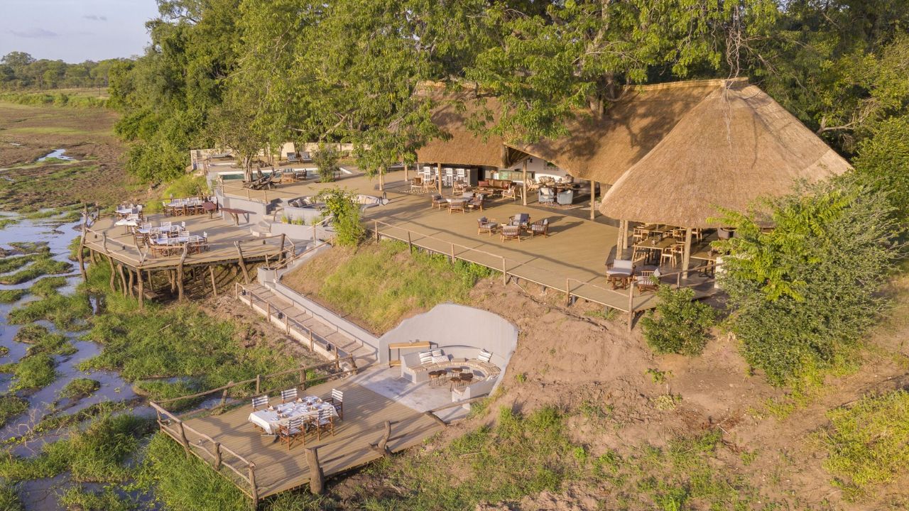 Aerial shot of Kafunta River Lodge showing thatched roof and open-plan design, bush surrounding lodge.