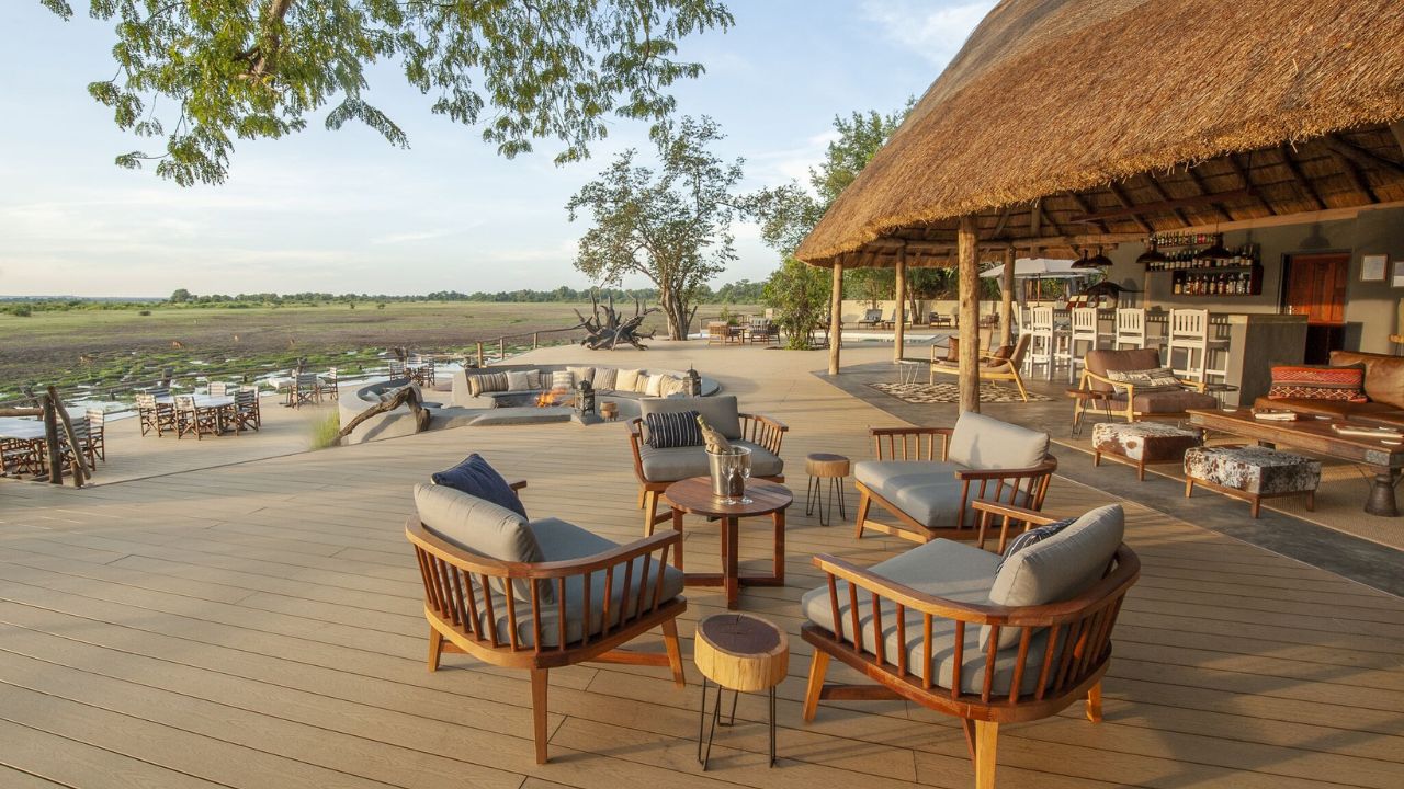 Main lodge deck area with seating for guests, overlooking bush, ideal for drinks and game viewing.