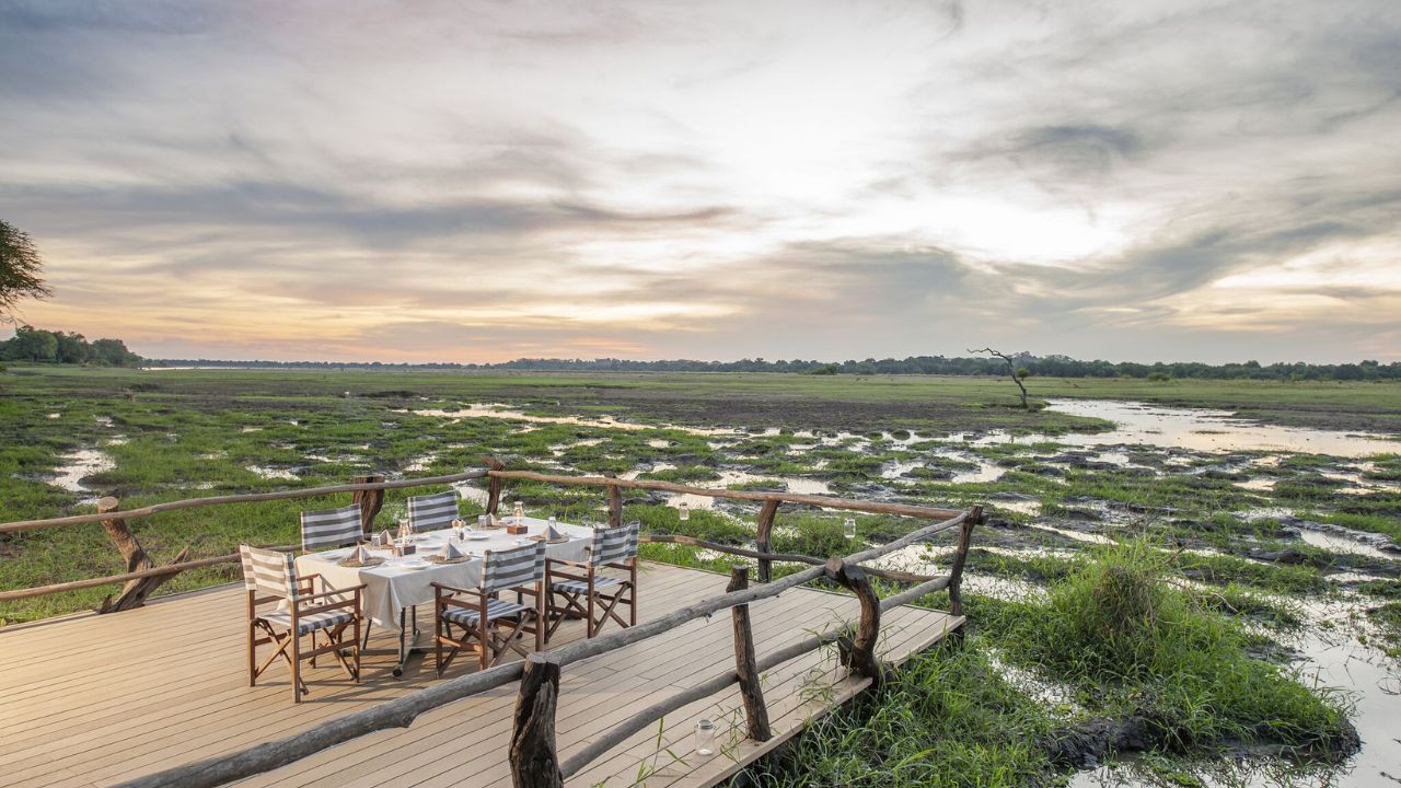 Evening dinner setting on outcrop deck, sunset over the bush