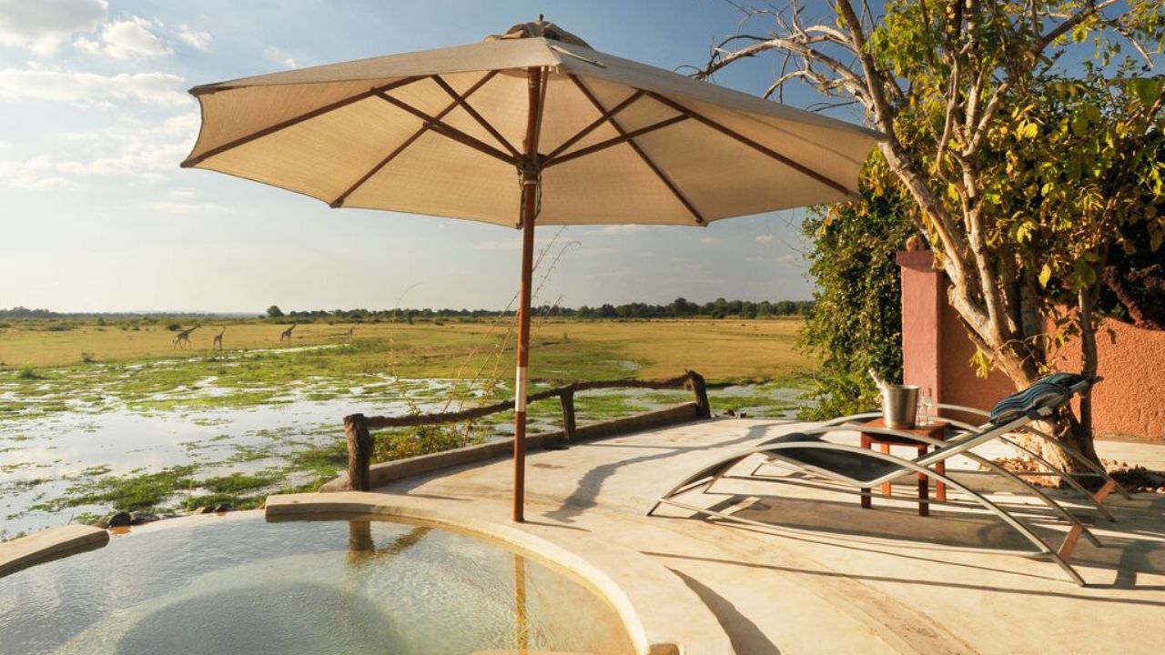 Small plunge pool with umbrella overlooking waterways and surrounding bush