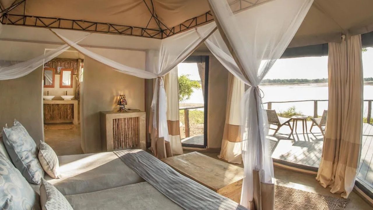 Casual stilted seating area with aerial view of river at Three Rivers Camp