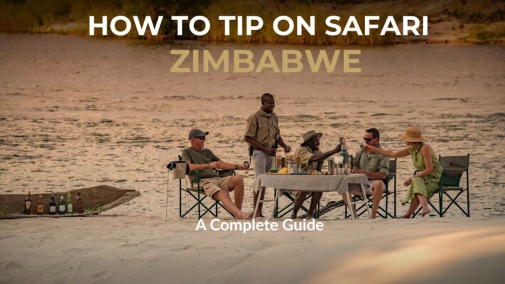 Guests enjoying sunset dinner on riverbank with Safari Guides - Words saying how to tip on a Zimbabwean Safari