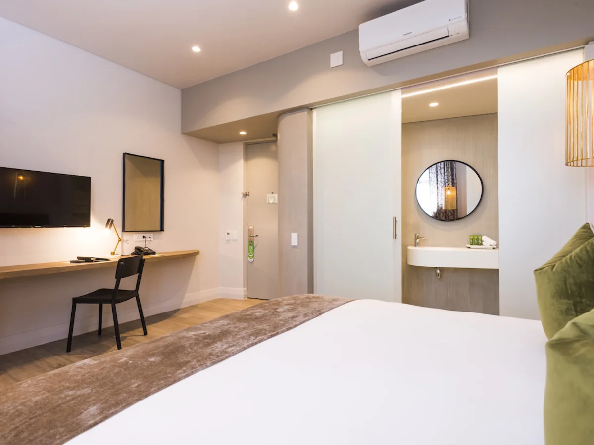 Modern double room with seating area at aha The Rex Hotel Knysna.