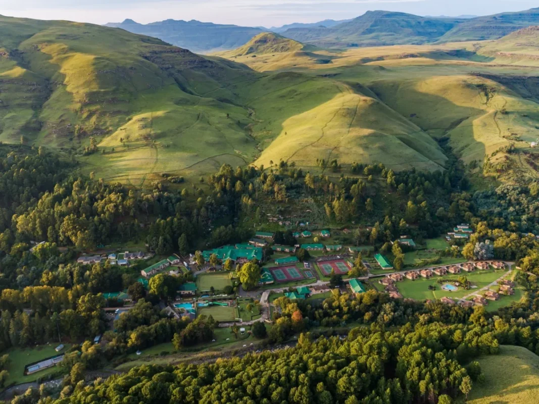 Aerial view of Gooderson Drakensberg Gardens Resort and mountains.