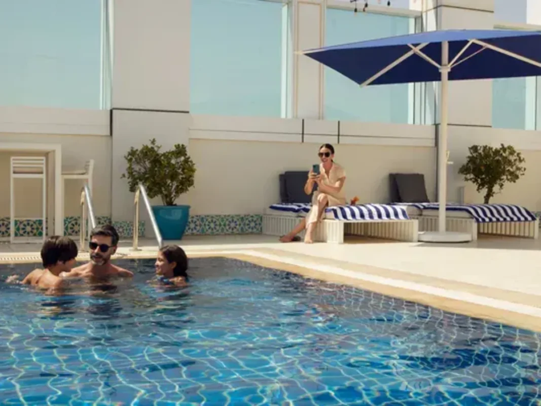 Swimming pool at Protea Hotel O R Tambo Airport Johannesburg with guests.
