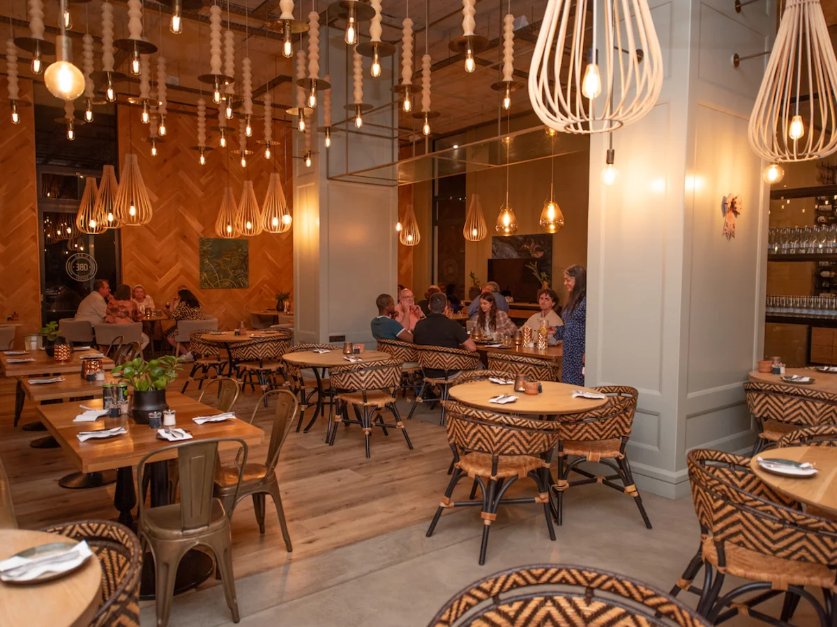 Dining area with guests enjoying dinner at aha The Rex Hotel Knysna.