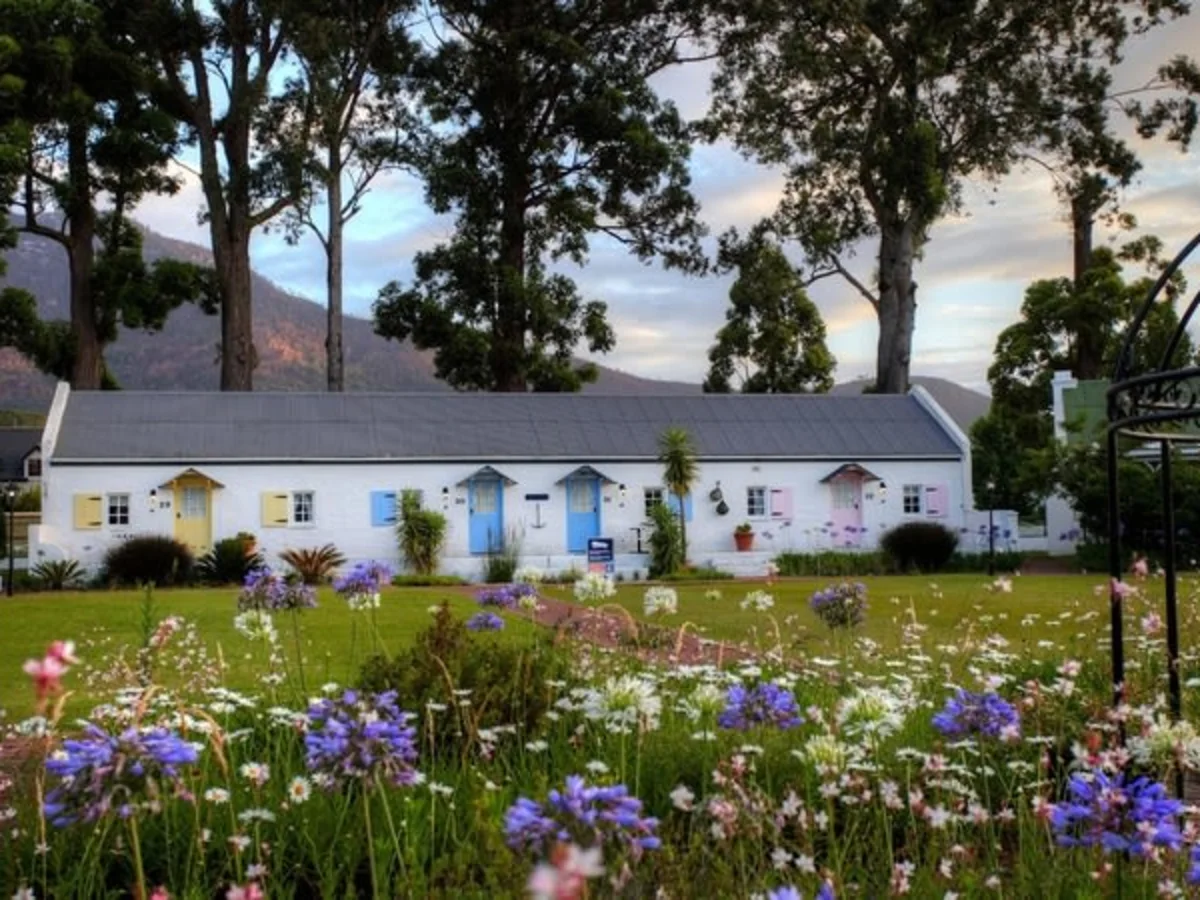 Tsitsikamma Village Inn surrounded by lush gardens and mountains in South Africa.