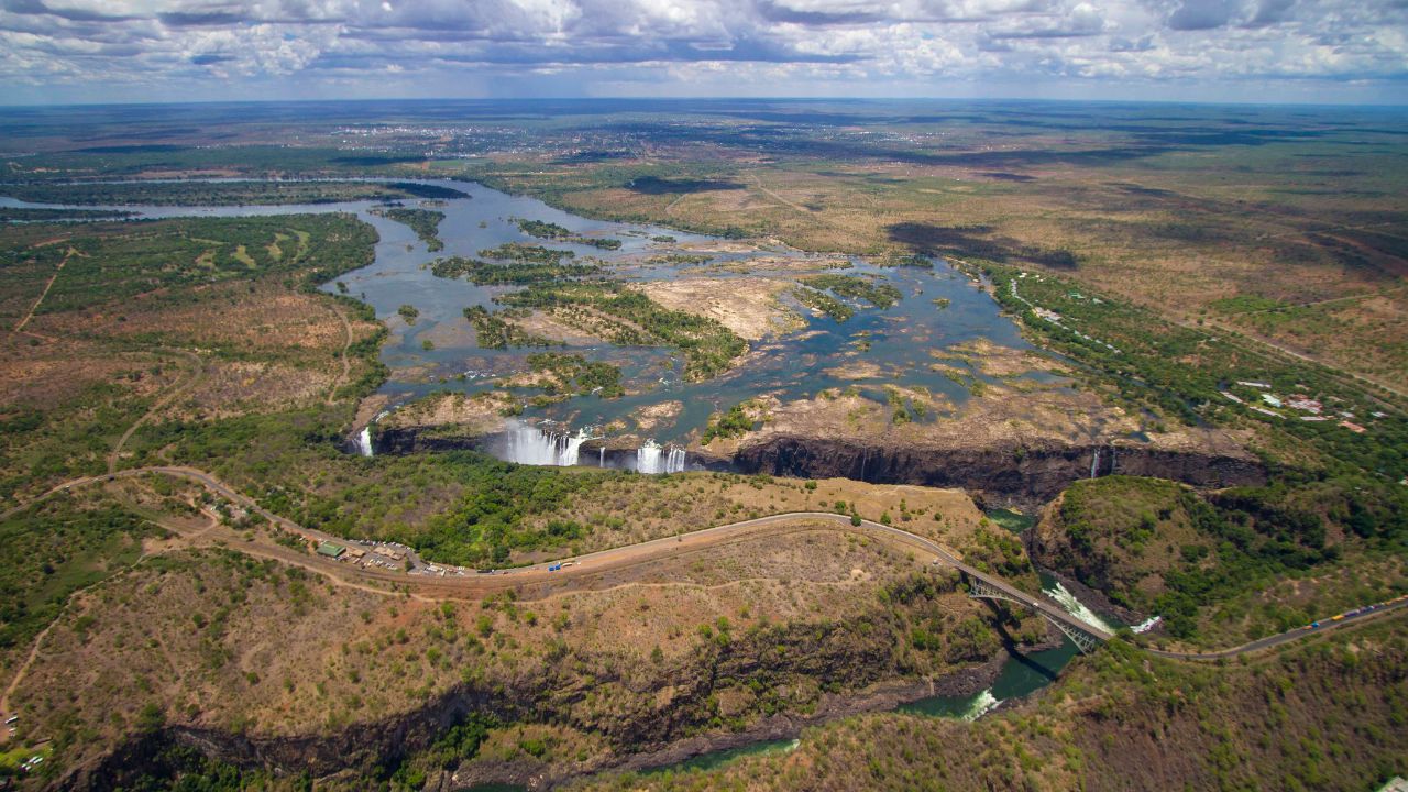 Victoria Falls aerial view as green vegetation returns and Zambezi water levels rise.